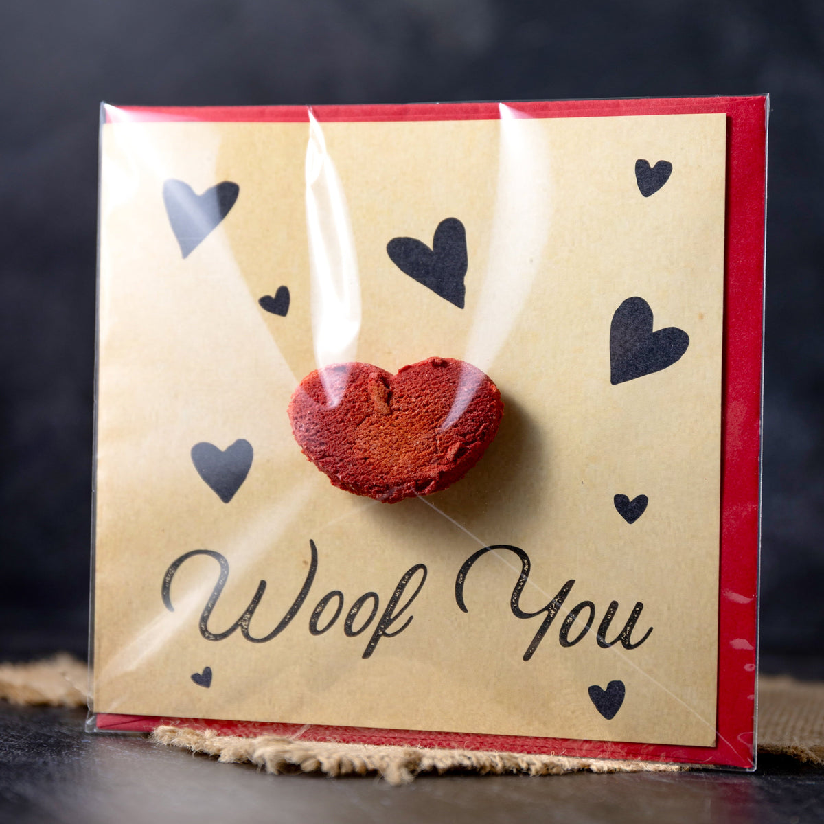 Card with a red heart and 'Woof You' text on a dark background