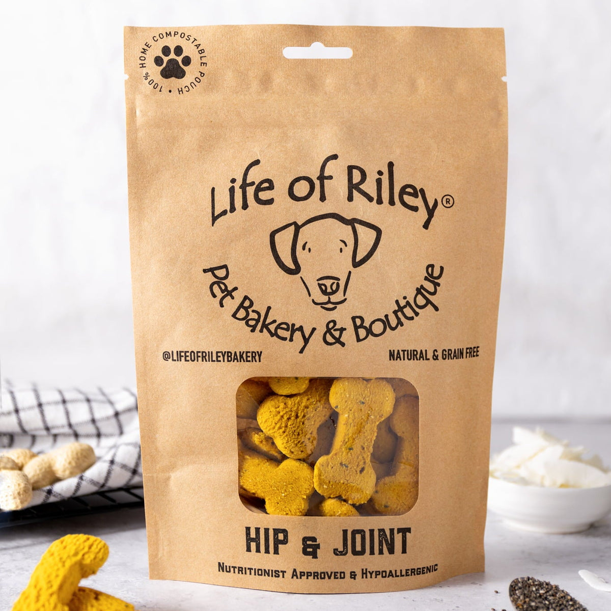 Bag of 'Life of Riley' dog treats on a white surface with visible ingredients.